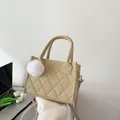 Beige quilted felt tote bag with plush ball charm and top handles for casual office style - Khaki