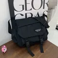 Large black nylon messenger bag with buckle closure and adjustable strap in Japanese style - Black