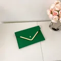 Elegant green envelope clutch bag with crocodile texture and gold V-shaped metal trim - Green