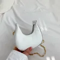 White snakeskin crescent bag with gold chain strap for minimalist fashion look - White