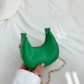 Mini emerald green crescent bag with snakeskin texture and gold chain strap - Green