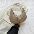 Chic beige hobo underarm bag featuring a gold heart buckle and metal chain detail - Off White