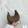 Dark brown crescent bag with snake skin texture and a stylish gold chain strap - Brown