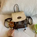 Mini bicolor backpack in dark brown and beige faux leather with plush monster charm - White & Coffee