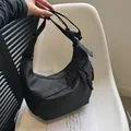 Minimalist black half-moon tote bag in matte nylon with adjustable shoulder strap - Black