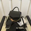 Elegant black faux leather crossbody bag with crocodile embossing and gold chain - Black