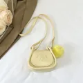 Mini cream yellow saddle bag with cartoon girl engraving and yellow plush pendant - Yellow