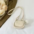 Mini cream white saddle bag with cartoon girl relief and fuzzy pompom accessory - Off White