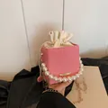 Fashionable red and white striped bucket bag with pearl handle and golden chain strap - Pink