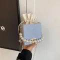 Light blue woven bucket bag with pearl handle and inner drawstring pouch detail - Blue