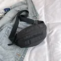 Minimalist black nylon crossbody chest bag with adjustable strap and embroidered logo - Black