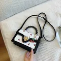Chic white crossbody bag with red cherry print and golden flower lock detail - Black
