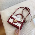 Red and white cherry print handbag with woven handle and gold flower clasp - Red