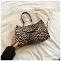 Detailed view of leopard print crescent bag with silver T-logo clasp and chain strap - Khaki