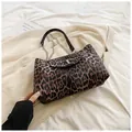 Detail of leopard print crescent bag featuring metallic T-logo and silver chain strap - Brown