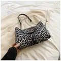 Close-up of leopard print crescent bag with silver T-lock and chain strap detail - Black