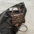 Elegant leopard print hourglass bag with gold hardware and adjustable shoulder strap - Brown Leopard