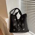 Minimalist black corduroy tote bag with white embroidery and casual shoulder strap design - Black