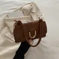Caramel brown PU leather shoulder bag with gold U-buckle and knotted strap detail - Brown