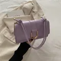 Light purple leather shoulder bag with a gold horseshoe buckle and knotted strap - Purple