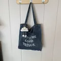 Deep blue denim tote bag with Catch the Good Things print and cloud plush charm - Style 3 Light Blue Open