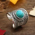 Detailed macro view of retro woven metal ring with turquoise stone inlay on wood - Oval Turquoise Braided Style (HJ10742) / Silver
