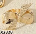 Detailed close-up of a gold-plated bow ring with radial vertical texture and adjustable band - Vertical Striped Bow Style (x2328)