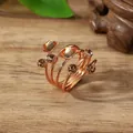 Detail of rose gold spiral scarf ring with champagne gemstones on a wooden surface - One Size / Champagne (X2370)