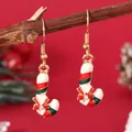 Macro view of candy cane Christmas earrings with enamel stripes and bow detail - Candy Cane (EH5791)