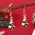 Detailed macro shot of alloy Christmas house earrings with green and red oil drip enamel - Church House (EH5793)
