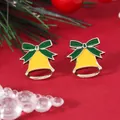 Macro detail of yellow bell earrings with green bows on a festive red background - Yellow Bell (EH5794)