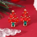 Macro view of Christmas tree earrings with red rhinestones on a festive red background - Red Christmas Tree (EH5802)