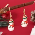 Detailed view of handmade enamel snowman Christmas earrings hanging on a rustic wooden branch - Snowman Hook (EH5964)