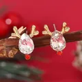 Macro detail of Christmas reindeer stud earrings with crystal antlers on a rustic wood branch - Reindeer Stud (WEH042)