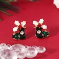 Macro view of Christmas boot earrings with black enamel, green rhinestones and gold edges - Black Xmas Boot (WEH1676)