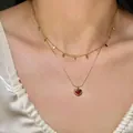Detail of double-layer gold necklace with red heart pendant worn on neck - Double Layer Heart Water Drop Chain / Gold