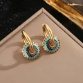 Detail of vintage flower enamel earrings in titanium steel with gold-plated finish - Enamel Flower Earrings