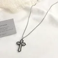 Macro detail of gothic cross pendant with white cubic zirconia and black bead outline - Silver