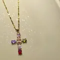 Close-up of golden cross necklace featuring vibrant multi-color zircon stones for women - Colorful Cross