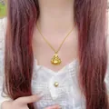 Golden Laughing Buddha pendant necklace worn by a model over a white lace collar - 45cm / Gold Plated Copper / Gold Buddha Pendant