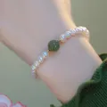 Elegant cat eye stone and pearl bracelet with green gemstone accent on female wrist - Freshwater Pearl (BNS-0253)