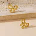 Elegant gold bow-shaped titanium steel stud earrings displayed on a natural textured stone - Bow-knot Stud Earrings (E092) / Gold