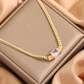 Luxurious gold necklace with a rectangular clear gemstone on a warm brown jewelry box - Square Zircon Gold Style (x734)
