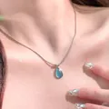 Elegant silver chain necklace featuring a teardrop-shaped blue cat-eye stone pendant - Waterdrop Blue Gemstone (x720) / Blue Gemstone / Steel Chain
