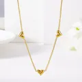 Elegant gold necklace featuring three heart-shaped pendants with inlaid cubic zirconia - Zirconia Inlaid Eight Hearts Necklace (X638)