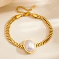 Elegant gold woven chain bracelet featuring a large oval white pearl in French retro style - Oval Artificial Pearl Bracelet (S4059)