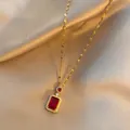 Elegant gold necklace with rectangular red pendant and white zircon inlay on champagne silk - Red Gemstone Necklace / Gold
