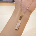 Detail of 18K gold bamboo necklace with pink faux jade pendant and sparkling zircon inlay - Gold White Bamboo Red Zircon (Lip Chain)