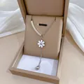 Detail of silver daisy flower pendant necklace on a jewelry box with satin lining - Titanium Steel / Silver