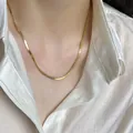 Elegant flat gold snake chain necklace for women worn with a white silk shirt - 3MM Snake Chain Gold
